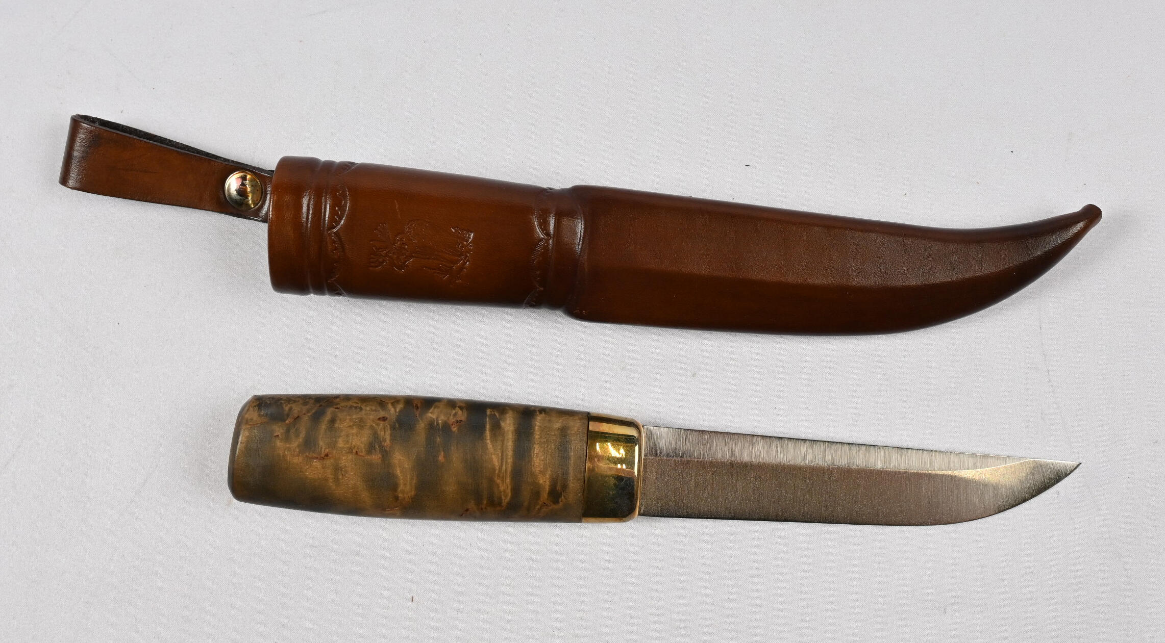 Knife with sheath marked “Elk” and “2009.” Normal signs of use