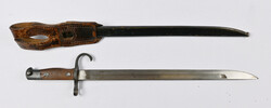 Bayonet with number, metal scabbard and frog. Length ca. 52,5 cm. ...