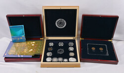 Selection of commemorative coins and circulated coins in three wooden ...