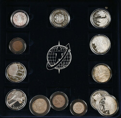 Selection of commemorative coins and circulated coins in three wooden ...