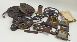 Lot of film accessories, including film spools, parts of a plate ...