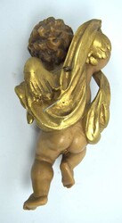 Putte aus Holz, farbig bemalt. Mit Wandaufhängung. Länge ca. 25 cm  ...