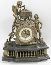 Beautiful ceramic clock with brass attachments. Two Bacchus figures ...