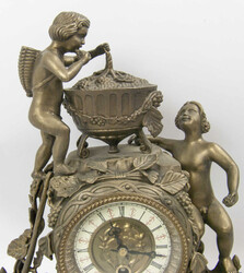 Beautiful ceramic clock with brass attachments. Two Bacchus figures ...