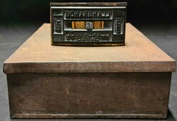 LLANGRANOG PARCEL POST HAND STAMPER: A small rusted metal box with ...